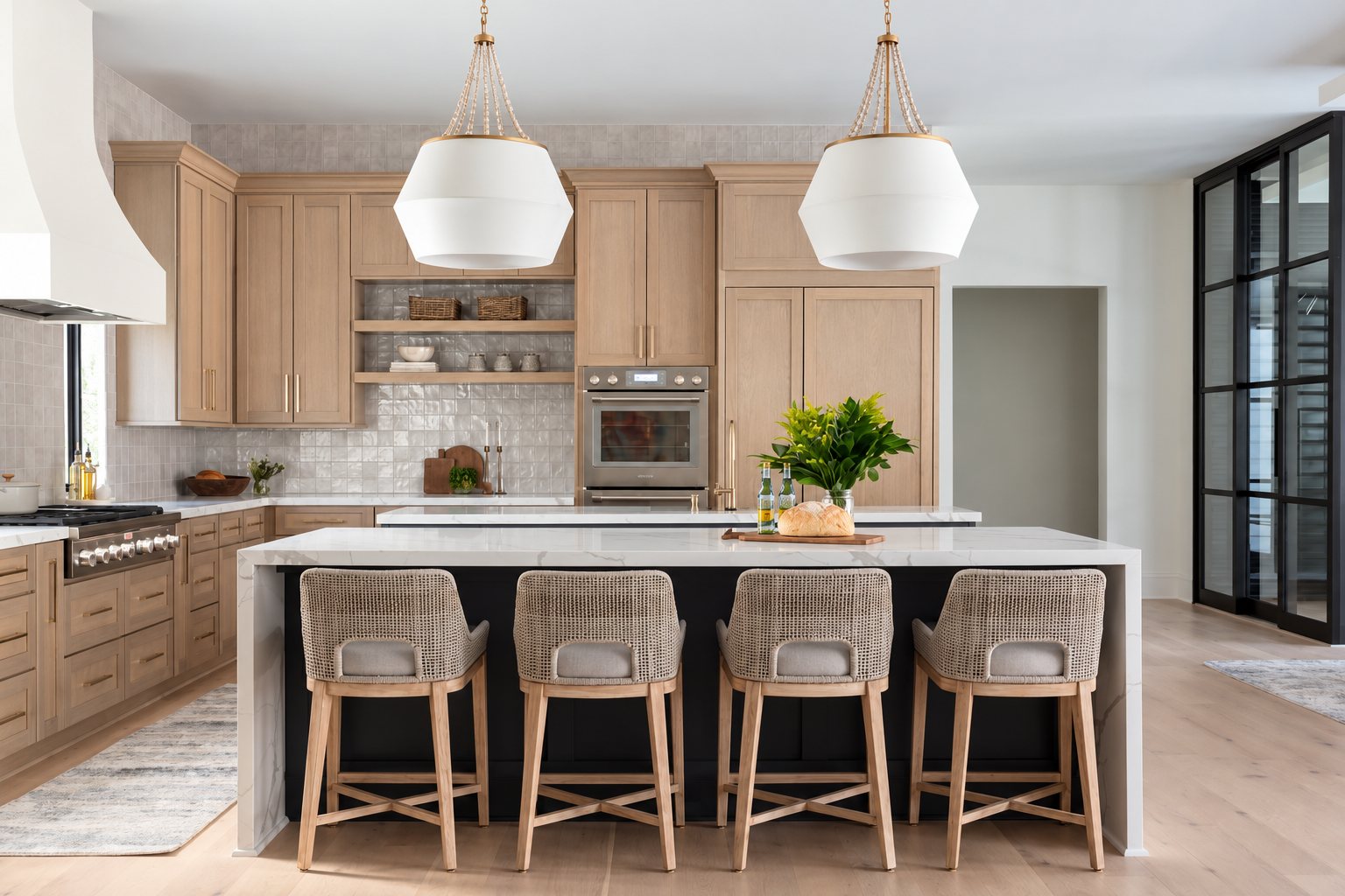 Light wood kitchen cabinets and woven stools around a white island